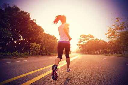 Runner athlete running on sunrise road