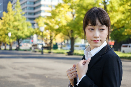 Young business woman walking on street