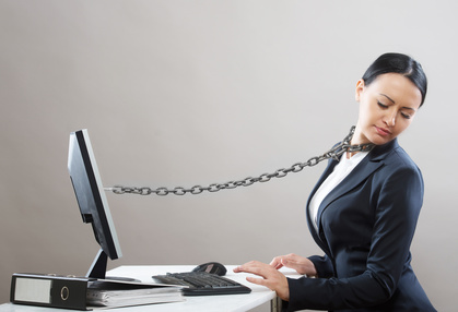 Female office worker chained to her computer